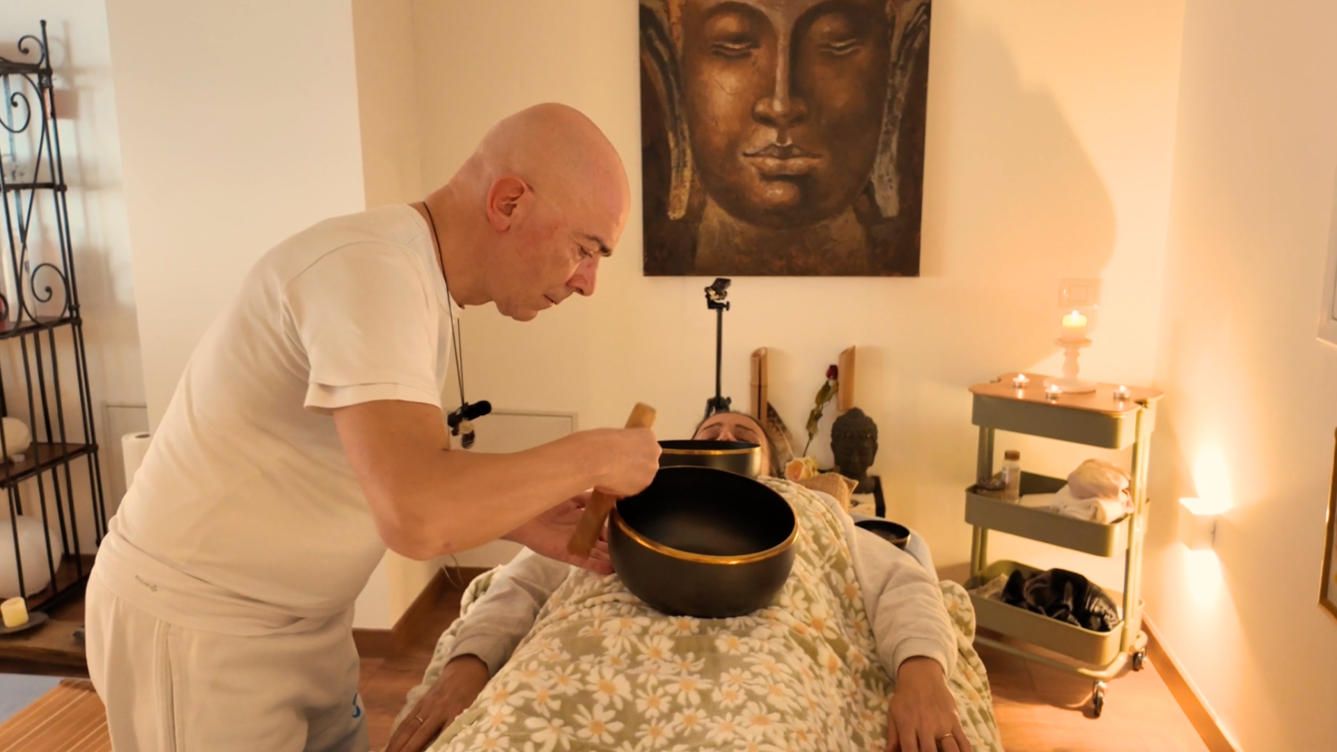 Domenico suona una campana tibetana durante un massaggio sonoro individuale
